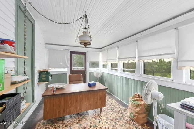 a living room with furniture a window and kitchen view
