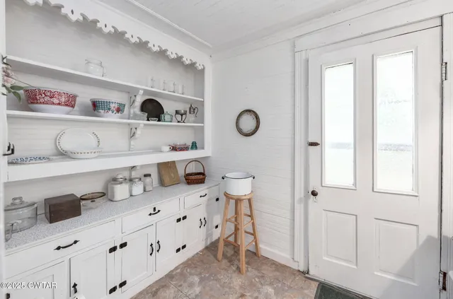 a kitchen with cabinets a sink and a window