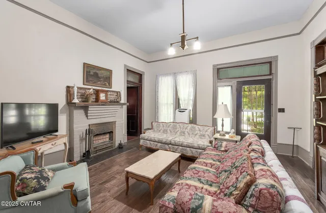 a living room with furniture and a flat screen tv