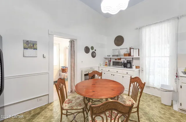 a dining room with furniture and window