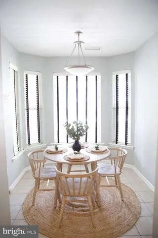 a dining room with furniture a chandelier and wooden floor
