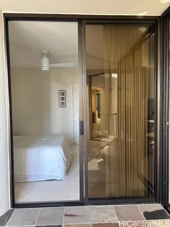 a bedroom with a bed and large window