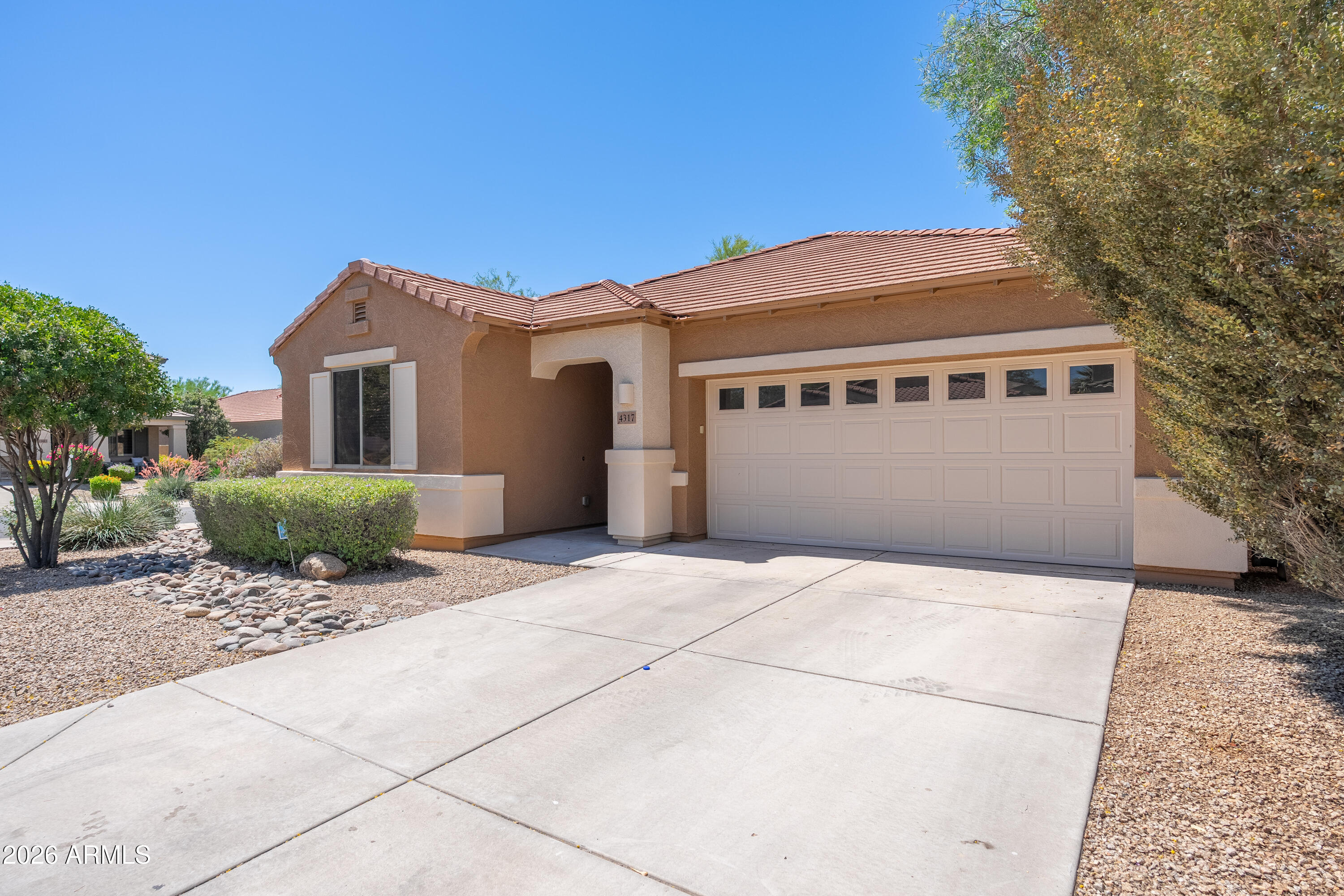 4317 East Folgers Road Phoenix, AZ 85050 - Photo 2 of 40 a front view of a house with a garage