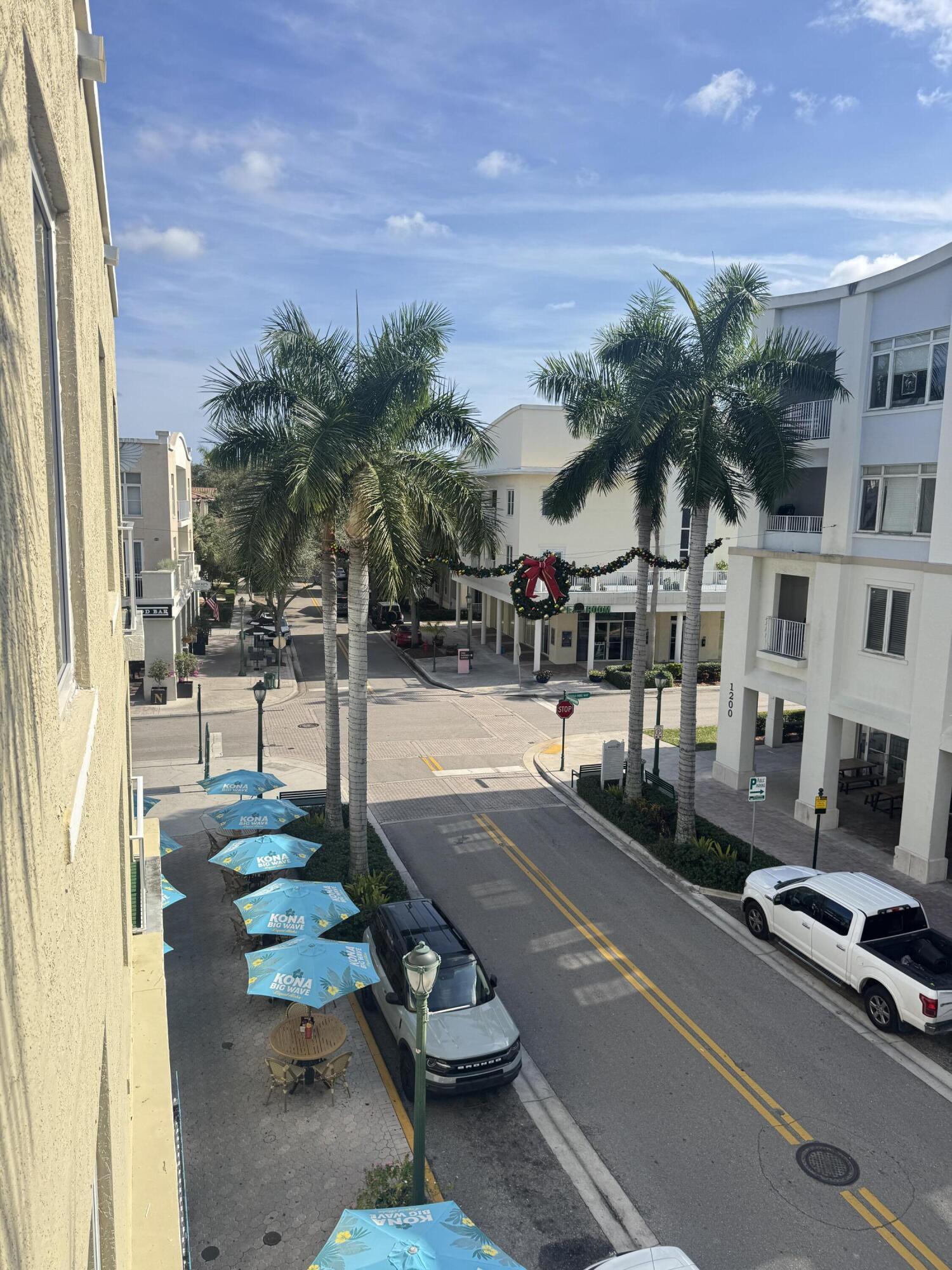 1203 Town Center Drive, Unit 306 Jupiter, FL 33458 - Photo 21 of 21 a view of a patio with swimming pool table and chairs