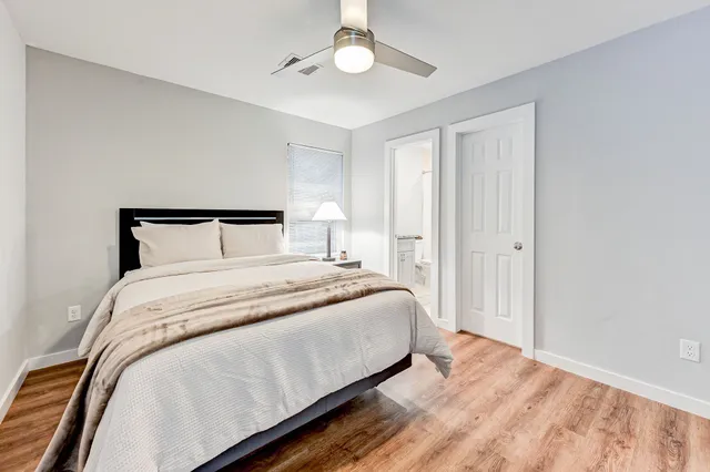 a bedroom with a bed and a chandelier