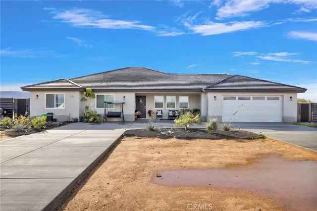 a front view of a house with yard outdoor seating and barbeque oven
