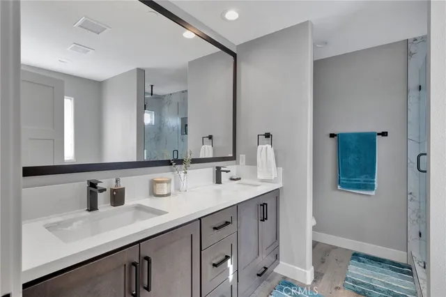 a bathroom with double sink and a mirror