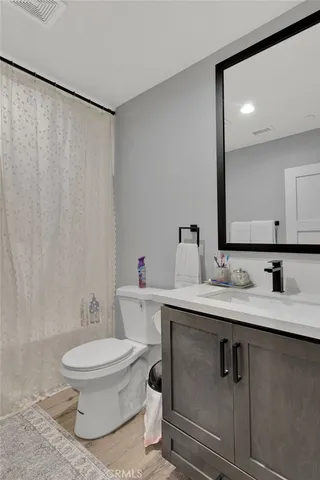 a bathroom with a toilet a sink and a mirror