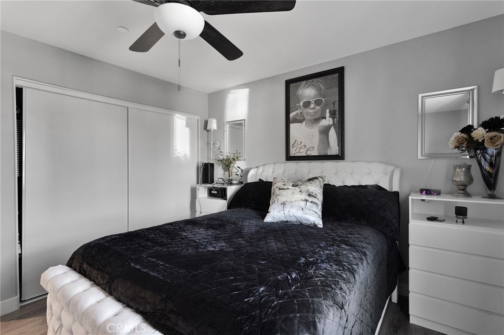 21533 Del Oro Road Apple Valley, CA 92308 - Photo 22 of 35 a bedroom with a large bed and a chandelier