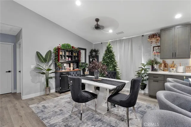 a kitchen with stainless steel appliances kitchen island granite countertop a sink and a refrigerator