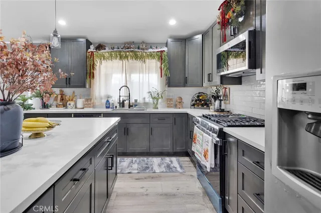 a kitchen with a sink stove and cabinets