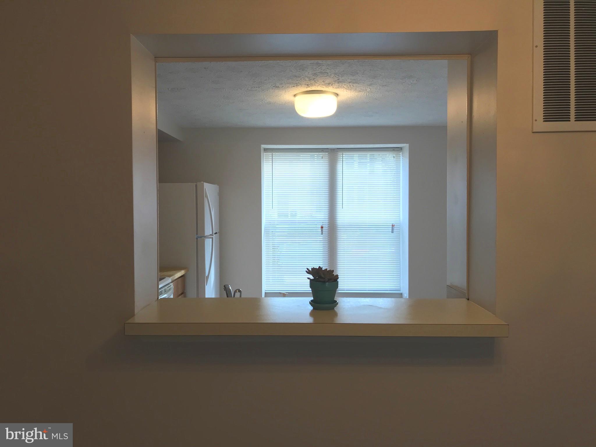 15821 Haynes Road Laurel, MD 20707 - Photo 7 of 16 BAR TO SIT AT OR PASS THRU TO LIVING/DINING ROOM