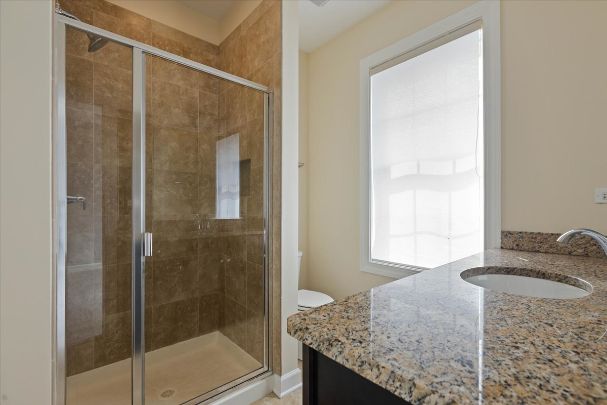 1669 Church Street Evanston, IL 60201 - Photo 15 of 31 a bathroom with a granite countertop sink and mirror