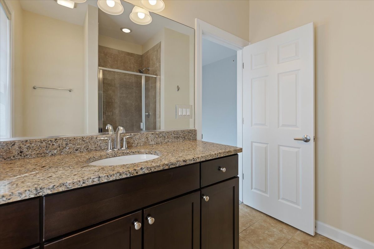 1669 Church Street Evanston, IL 60201 - Photo 16 of 31 a bathroom with a granite countertop sink and a mirror