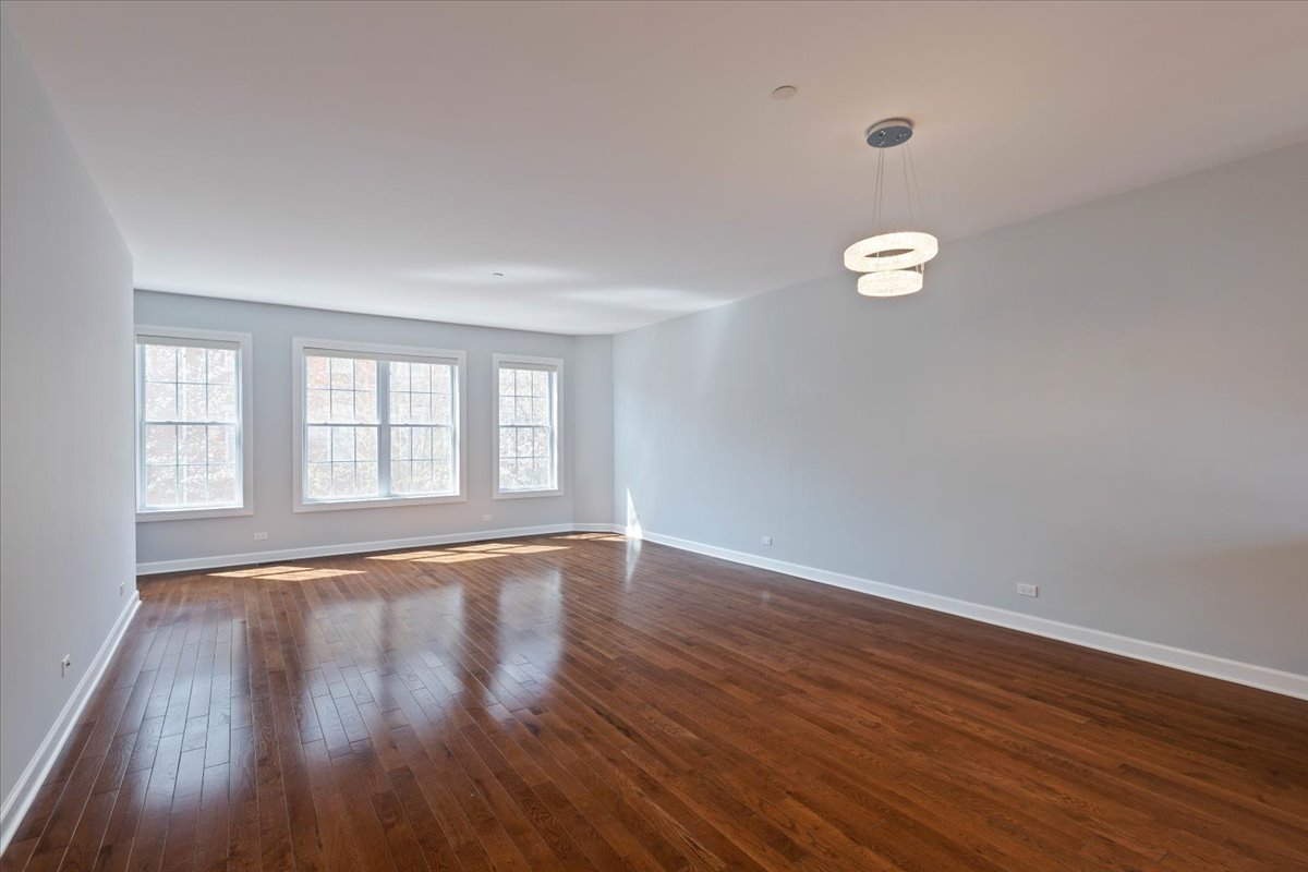 1669 Church Street Evanston, IL 60201 - Photo 7 of 31 a view of an empty room with wooden floor and a window