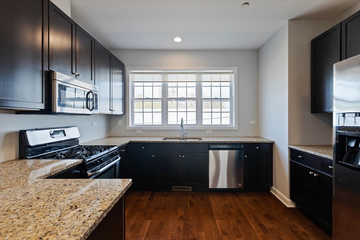 1669 Church Street Evanston, IL 60201 - Photo 8 of 31 a kitchen with granite countertop stainless steel appliances and wooden cabinets