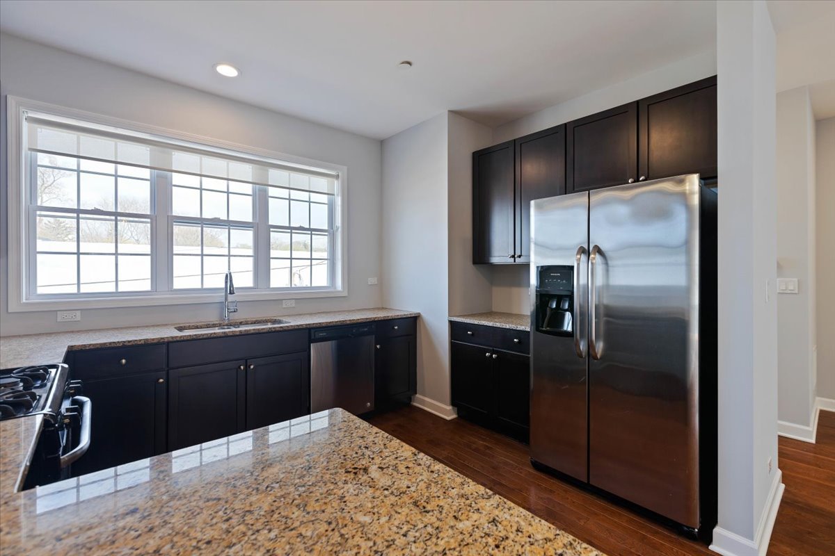 1669 Church Street Evanston, IL 60201 - Photo 10 of 31 a kitchen with a refrigerator and a sink