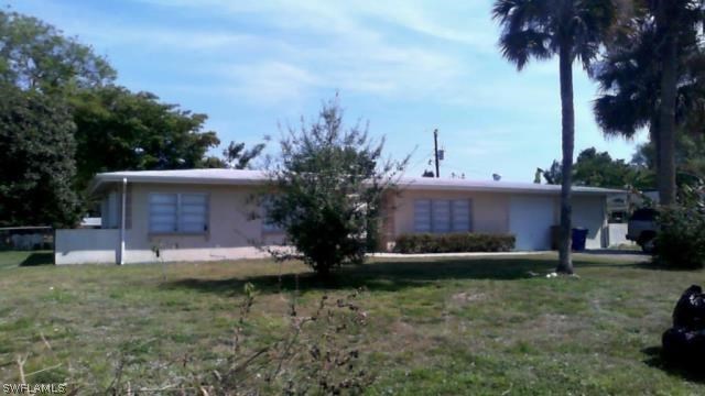 1003 East Penn Road Lehigh Acres, FL 33936 - Photo 1 of 12 a view of a house with a yard and tree s