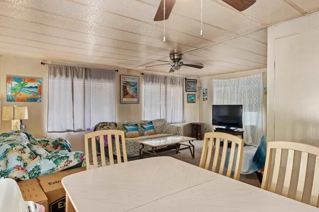 a kitchen with a cabinets a stove a table and chairs