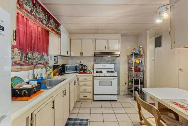 a bedroom with a bed a dresser and a large mirror
