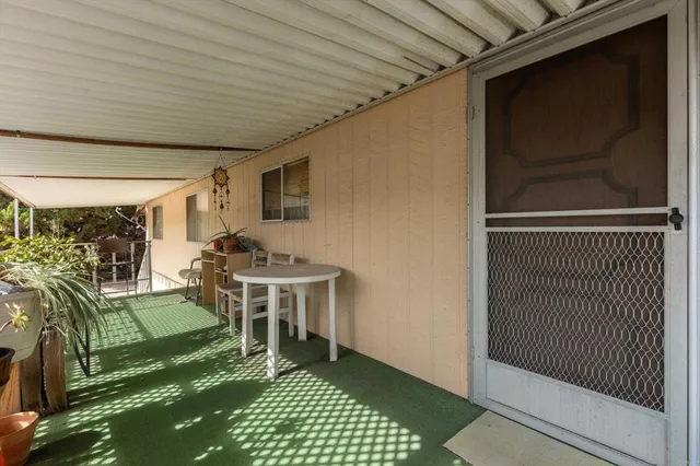 a living room with a rug floor and a table