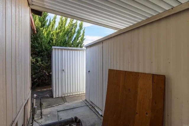 a backyard of a house with table and chairs