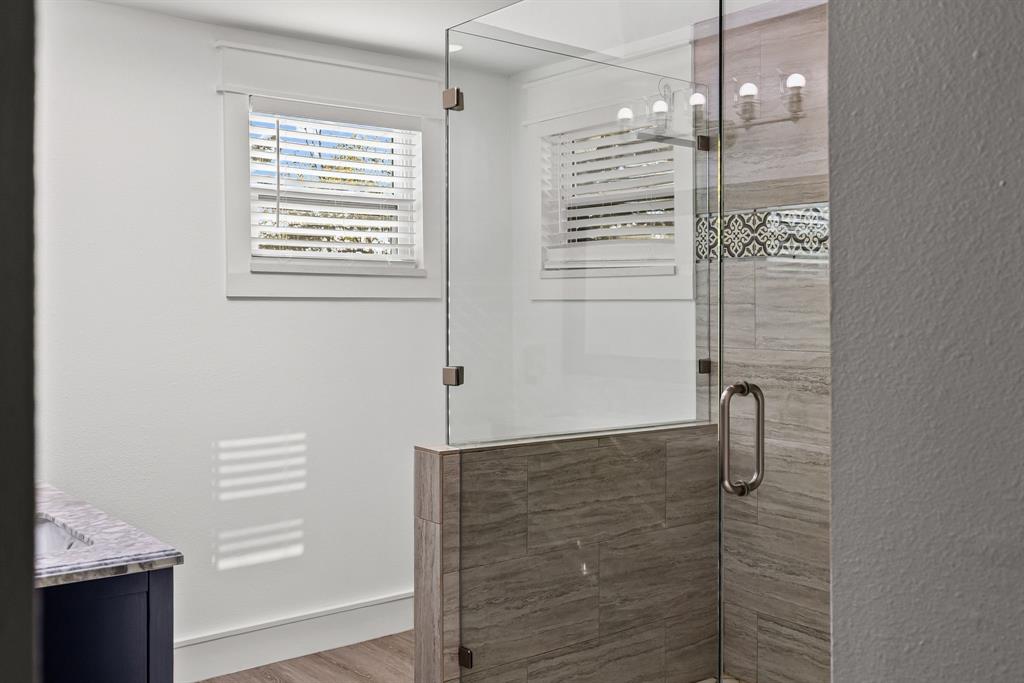 509 Maple Street Commerce, TX 75428 - Photo 23 of 36 a bathroom with a shower and a sink