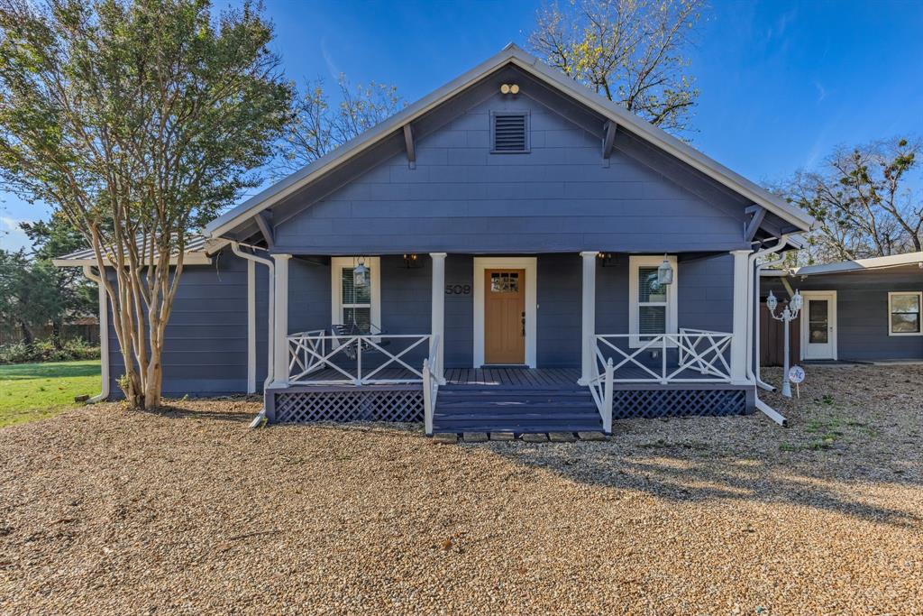 509 Maple Street Commerce, TX 75428 - Photo 3 of 36 a front view of a house with garden