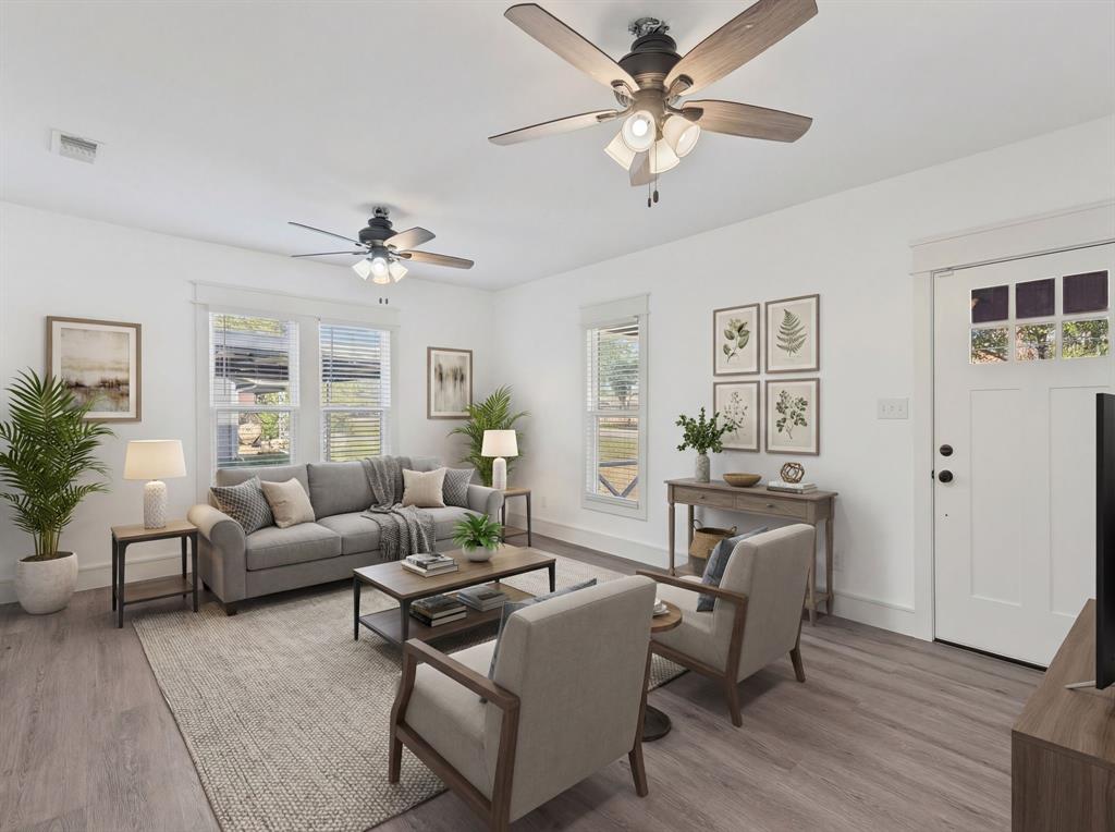 509 Maple Street Commerce, TX 75428 - Photo 7 of 36 a living room with furniture a chandelier fan and a window