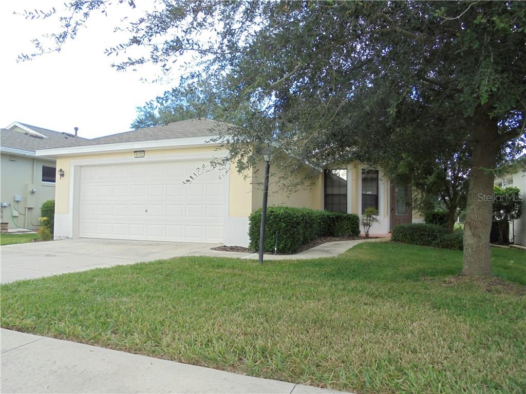 6105 Hunters Ridge Avenue Leesburg, FL 34748 - Photo 1 of 1 a front view of house with yard and green space