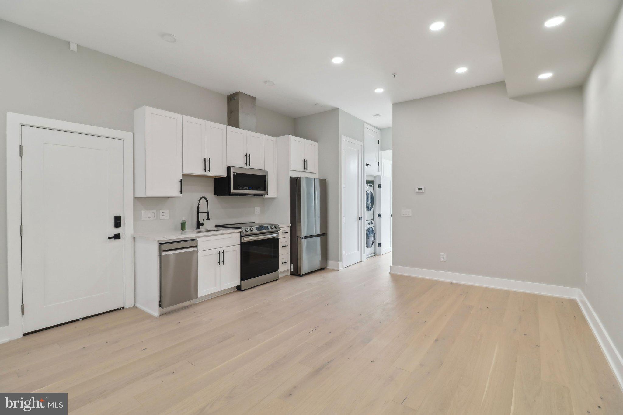 2213 M Street Northeast, Unit 4 Washington, DC 20002 - Photo 11 of 39 a kitchen with stainless steel appliances a refrigerator and a stove top oven