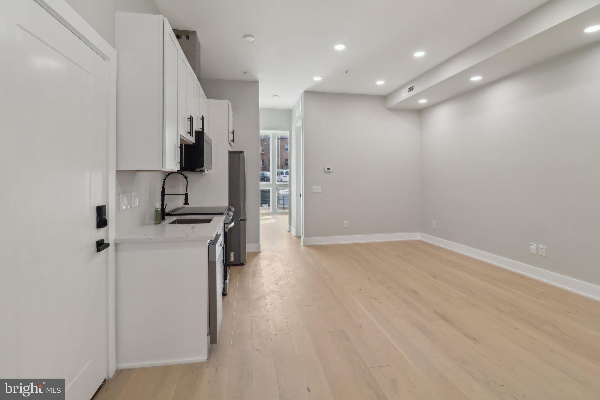 2213 M Street Northeast, Unit 4 Washington, DC 20002 - Photo 13 of 39 a kitchen with stainless steel appliances a refrigerator and a stove top oven
