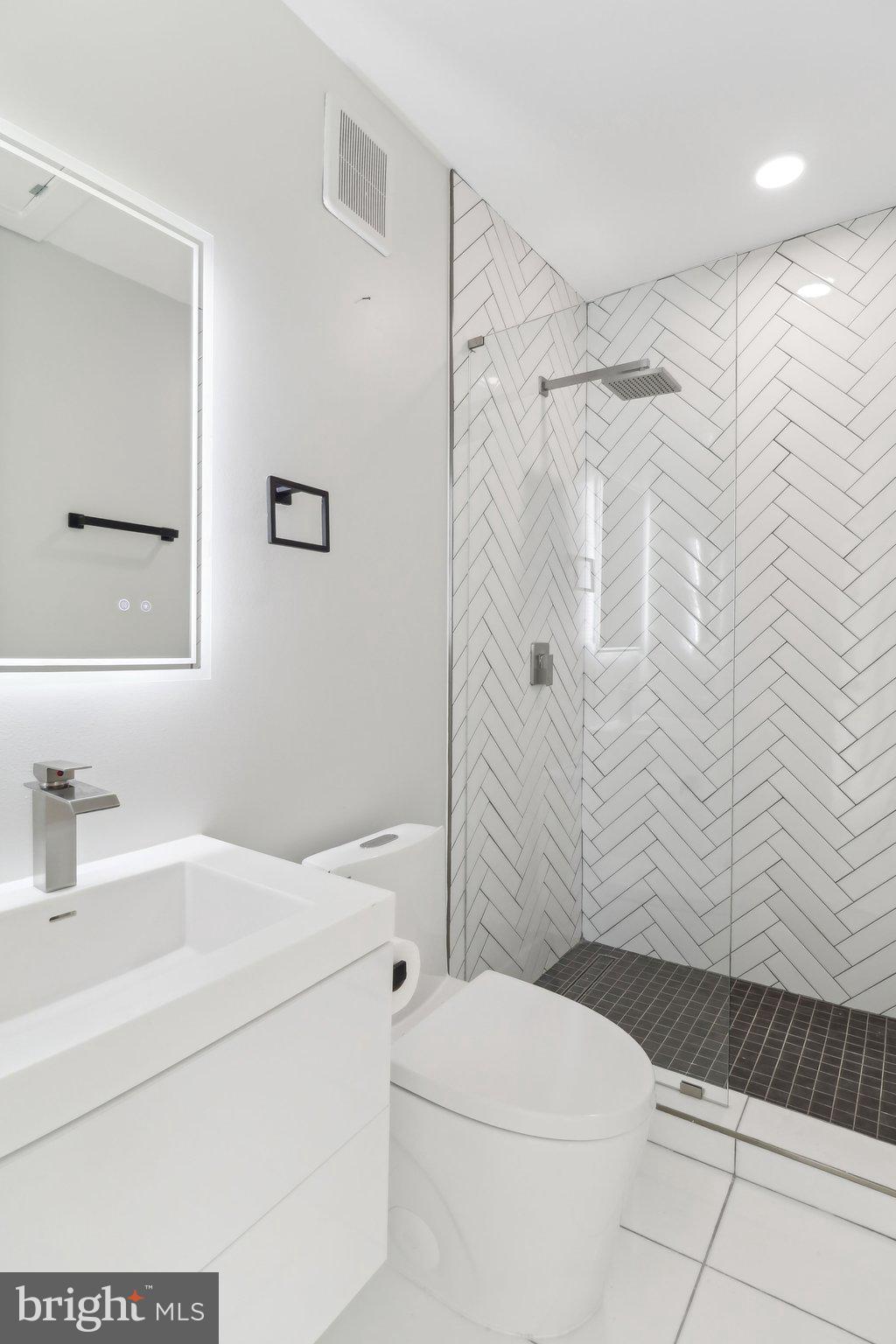 2213 M Street Northeast, Unit 4 Washington, DC 20002 - Photo 19 of 39 a bathroom with a sink toilet and shower