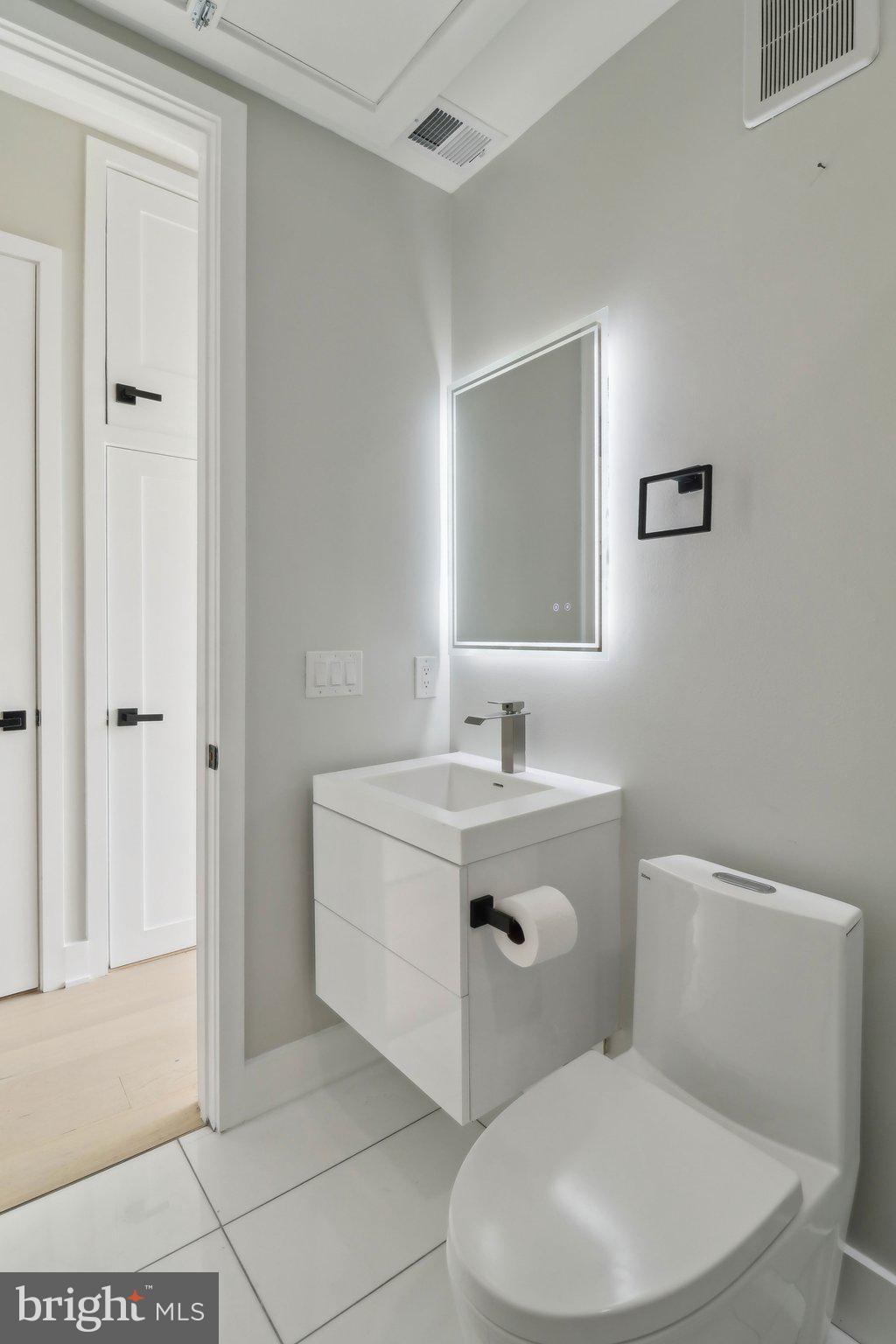 2213 M Street Northeast, Unit 4 Washington, DC 20002 - Photo 21 of 39 a bathroom with a toilet sink and mirror