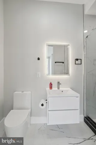 a bathroom with a shower sink and toilet