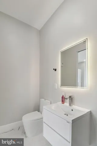 a view of a walk in closet with wooden floor