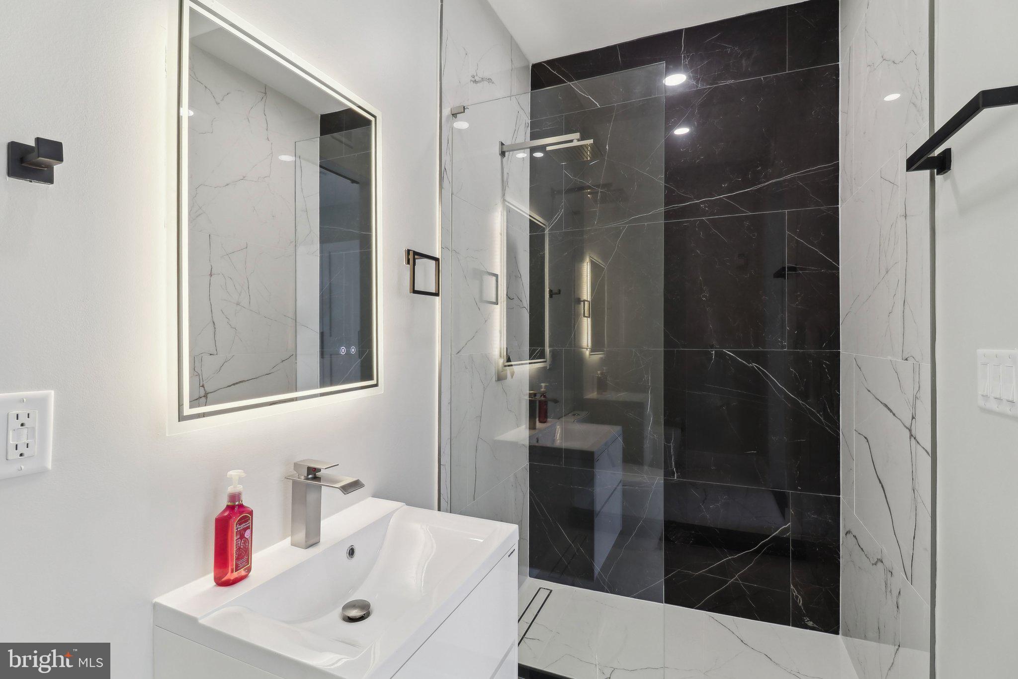 2213 M Street Northeast, Unit 4 Washington, DC 20002 - Photo 31 of 39 a bathroom with a shower sink and toilet