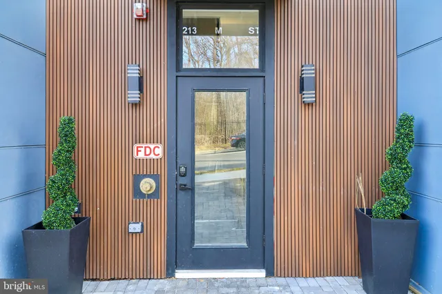 a view of entryway of a house with potted plants