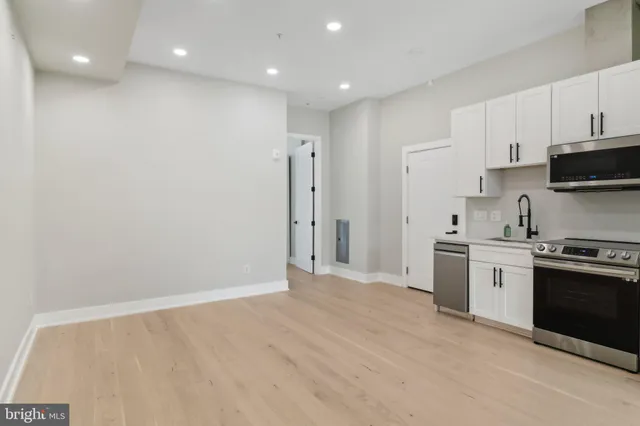 a kitchen with stainless steel appliances a refrigerator and a stove top oven