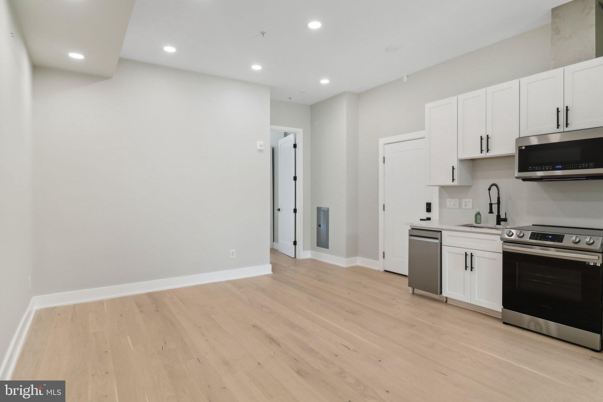 2213 M Street Northeast, Unit 4 Washington, DC 20002 - Photo 10 of 39 a kitchen with stainless steel appliances granite countertop a stove a sink and a refrigerator