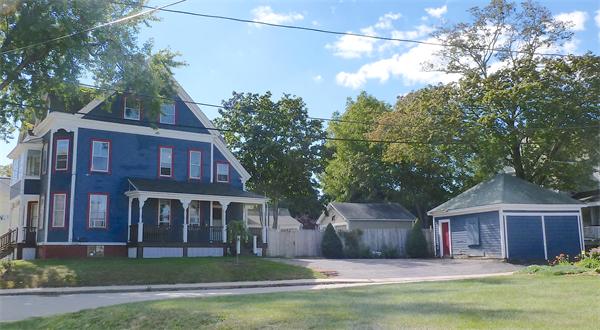 21 Congress Street Amesbury, MA 01913 - Photo 13 of 24 a front view of a house with a garden and plants
