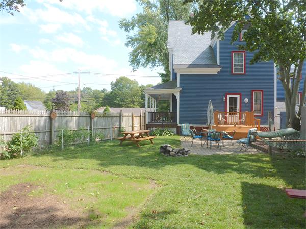21 Congress Street Amesbury, MA 01913 - Photo 14 of 24 a view of backyard of house with outdoor seating and green space