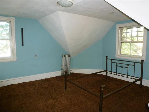 21 Congress Street Amesbury, MA 01913 - Photo 21 of 24 a view of a livingroom with a ceiling fan and window