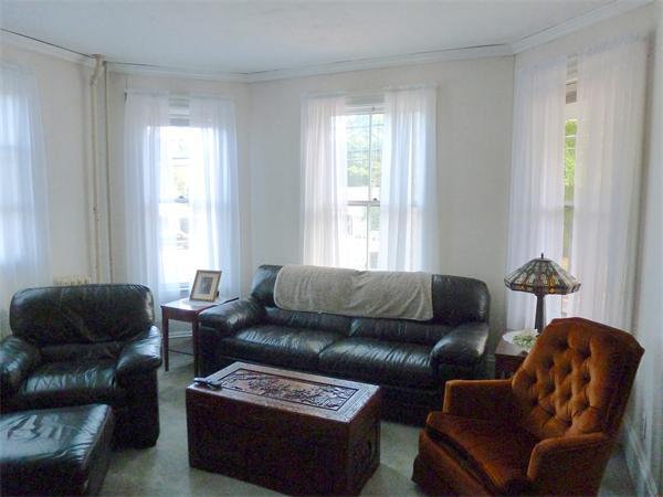 21 Congress Street Amesbury, MA 01913 - Photo 5 of 24 a living room with furniture and a window
