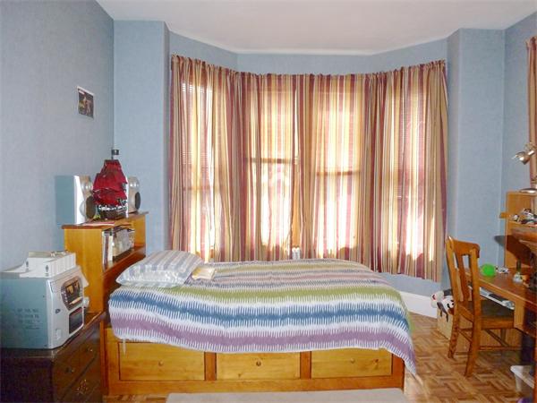 21 Congress Street Amesbury, MA 01913 - Photo 7 of 24 a bed sitting in a bedroom next to a window