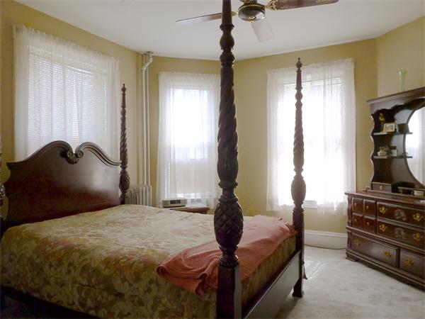 21 Congress Street Amesbury, MA 01913 - Photo 8 of 24 a bedroom with a bed and a mirror