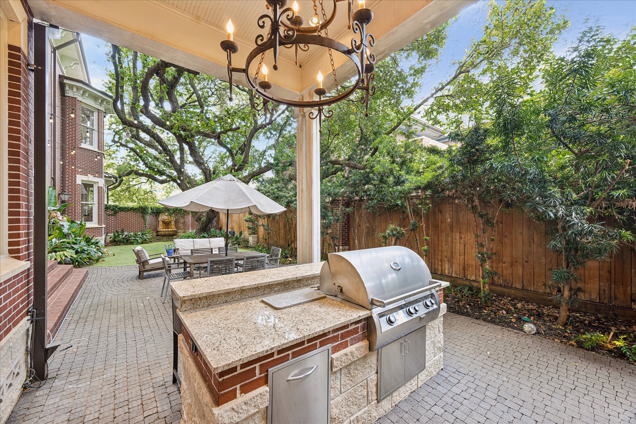 2368 Timber Lane Houston, TX 77027 - Photo 42 of 46 Designed with entertaining in mind, the covered summer kitchen is outfitted with a FireMagic grill, sink, and disposal.