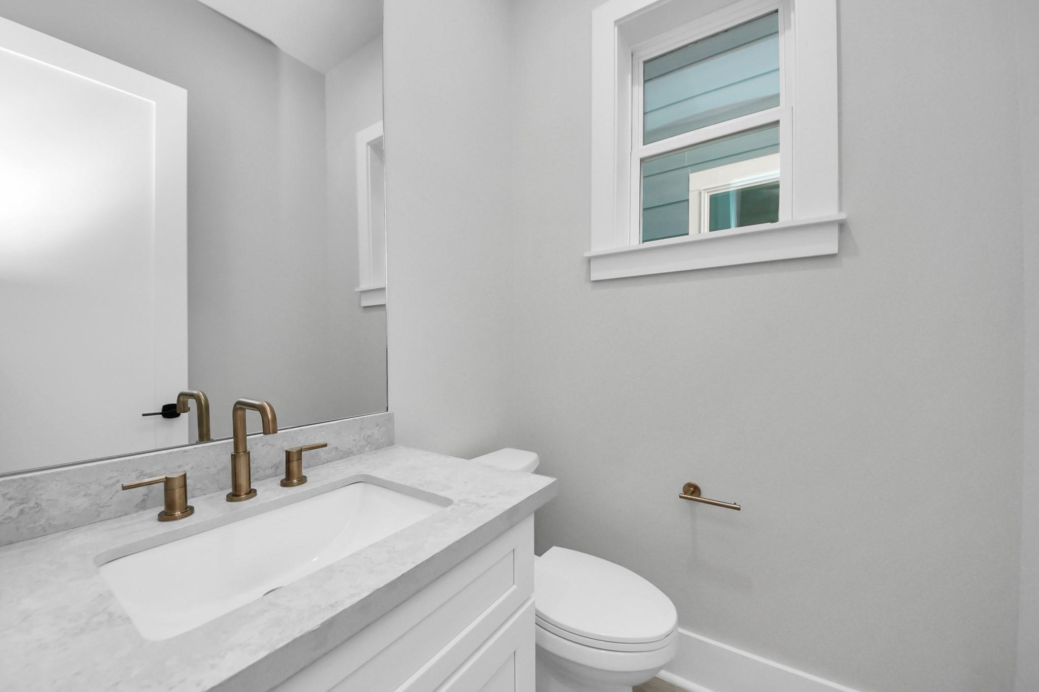 6320 Milwee Street, Unit B Houston, TX 77092 - Photo 26 of 30 a bathroom with a granite countertop sink mirror vanity and toilet