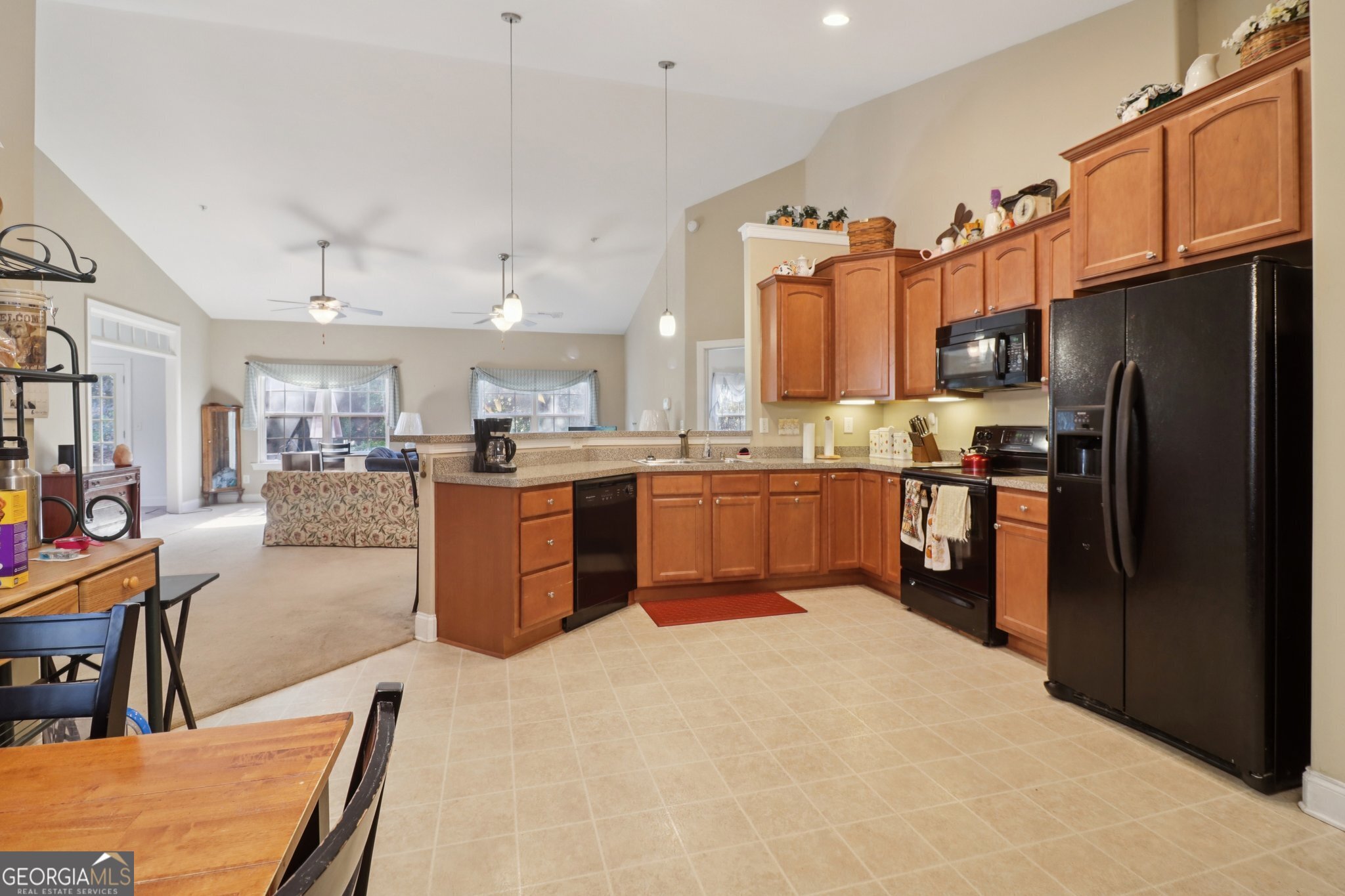 1502 Commonwealth Circle Newnan, GA 30263 - Photo 7 of 30 a kitchen with stainless steel appliances granite countertop a refrigerator and a stove