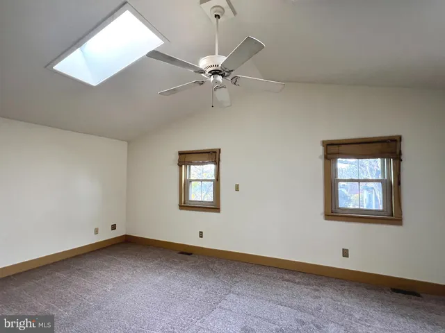 an empty room with a empty space and a ceiling fan